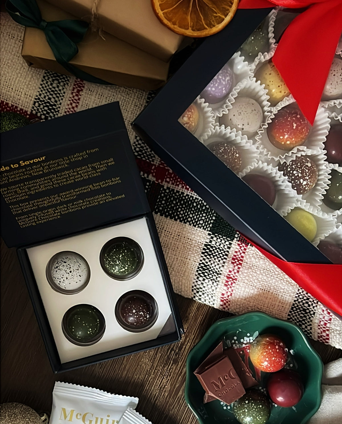 Chocolate truffles in a box with a magazine on a textured surface